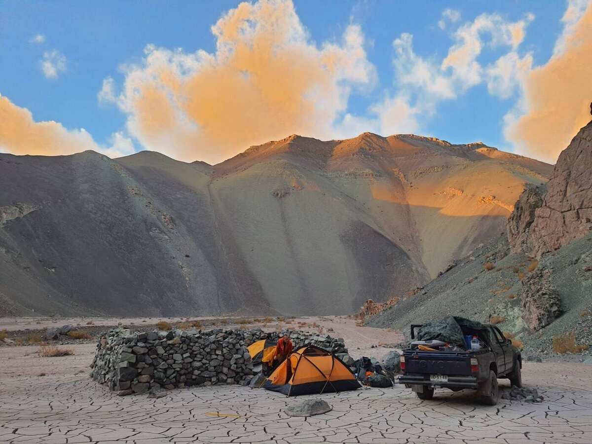 A high-desert mountain camp at sunset